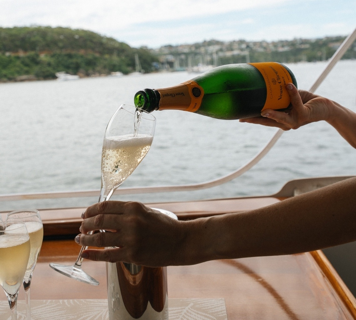 Stewardess Pouring Glass of Champagne